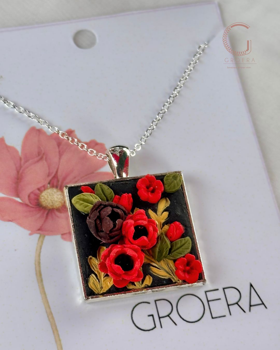 Necklace with floral pendant on a white card with 'GROERA' branding