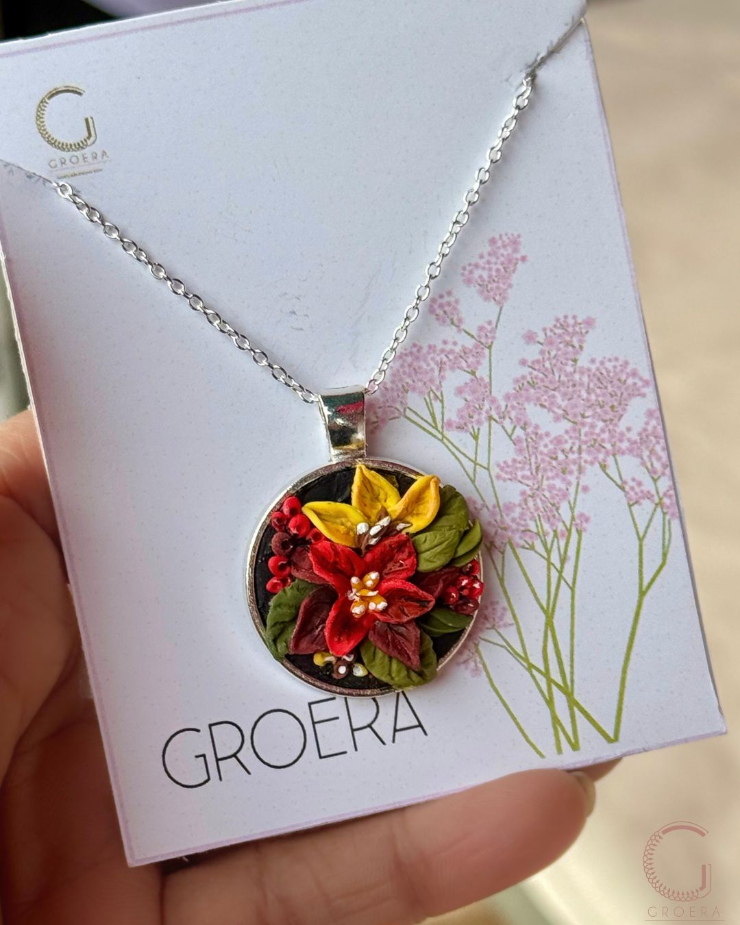 Nature-inspired handmade silver pendant with detailed flower design
