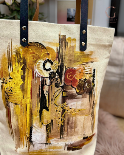 Tote bag with abstract art design featuring yellow, black, and brown colors.