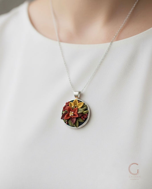 Handcrafted sterling silver floral pendant with autumn-colored flowers